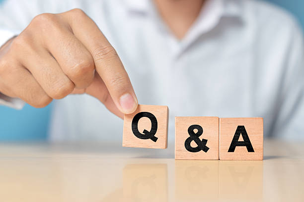 istock Q and A alphabet on wooden cube in hand hold with background. Question and answer meaning 2227983409