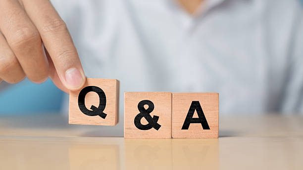 istock Q and A alphabet on wooden cube in hand hold with background. Question and answer meaning 2227983410