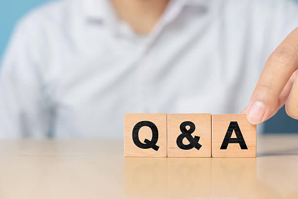 istock Q and A alphabet on wooden cube in hand hold with background. Question and answer meaning 2227983421