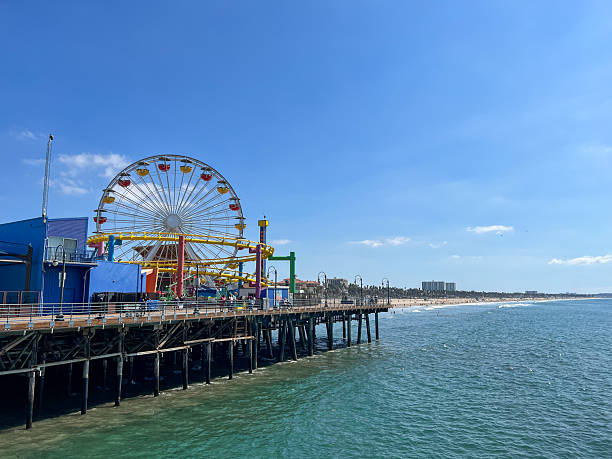 istock A pier with a Ferris wheel and a beach in the background 2227984377