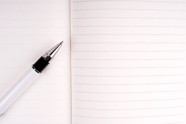 Ruled notebook and pen on an old desk