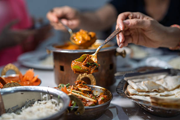 istock Spoonful of Indian Curry During Shared Meal 2227988212