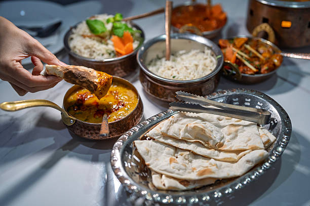 istock Hand Dipping Naan Bread into Indian Curry 2227988440