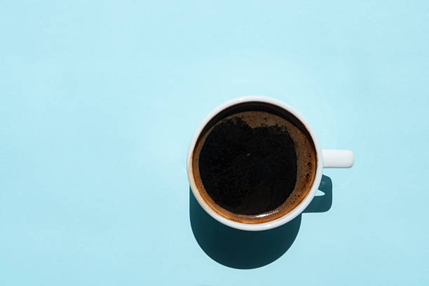Directly Above View Of Coffee In Cup On Blue Background
