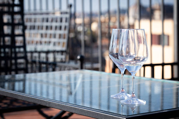 istock Two elegant wine glasses are beautifully placed on a glass table 2227990434