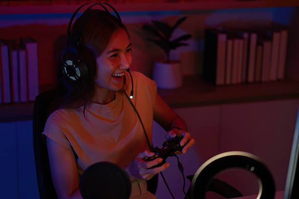 istock Joyful Gamer Celebrating Victory with Headset and Controller 2227991765