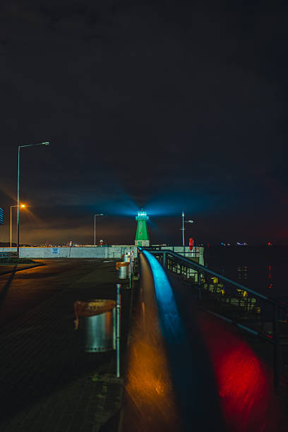 istock Green Lighthouse at Night on a Pier in Gdansk with Reflections 2227991768