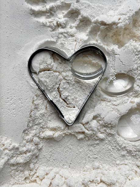 istock Heart shaped cookie cutter on top of flour 2227991941