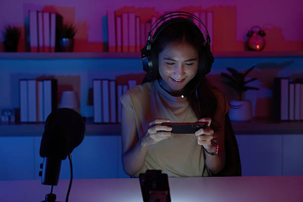 istock Focused Gamer Playing Mobile Game with Enthusiasm 2227992032