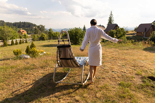 An early 30s attractive woman relaxing on an adirondock chair at a park in the spring.