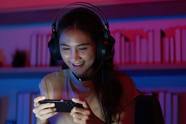 istock Focused Gamer Enjoying Mobile Game with Headset 2227992298