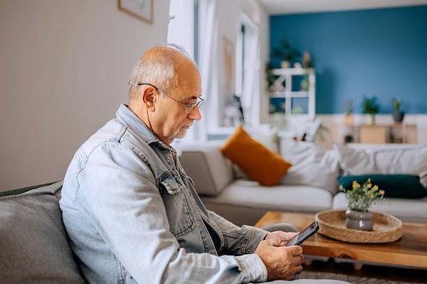 istock Senior man using phone at home 2227994658