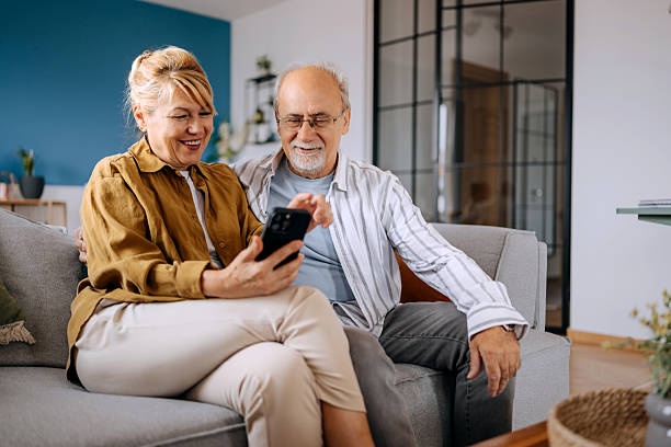istock Senior Couple Using Smartphone Together at Home 2227994810