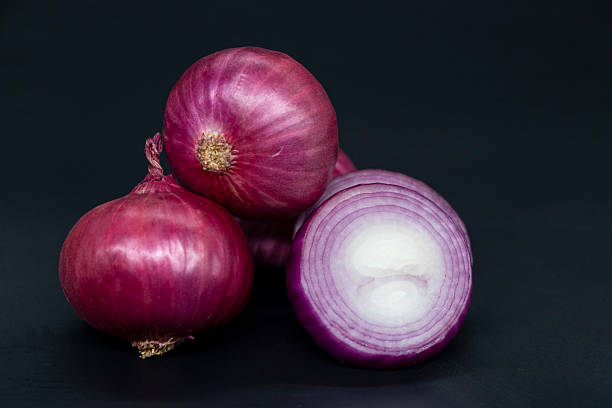 istock whole and slice Onion, isolated on black background 2227995932