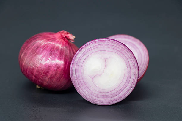 istock whole and slice Onion, isolated on black background. 2227996433