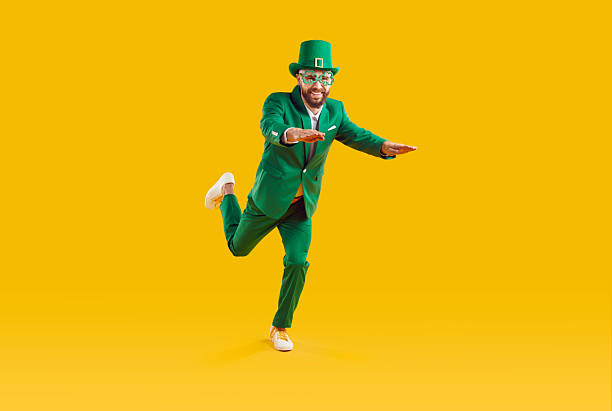istock Running St.Patrick. Bearded man in leprechaun hat with Clover. 2227998843