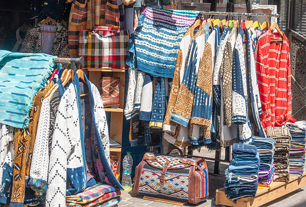 On the narrow streets Chefchaouen seliing national clothes, Morocco