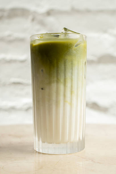 istock Cold macha latte in a glass with ice at the bar table 2228001957