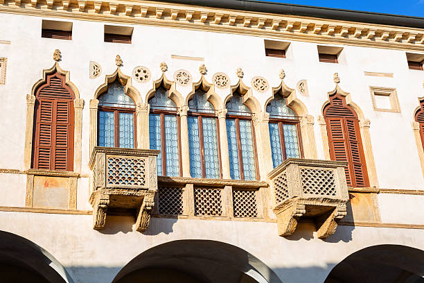 istock Historic building showcases ornate windows with decorative balconies and intricate stonework, bathed in vibrant sunlight, highlighting architectural beauty and craftsmanship 2228003196