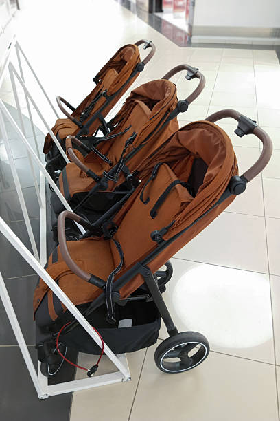 istock Brown baby strollers for rent in a row in a shopping mall. 2228006080