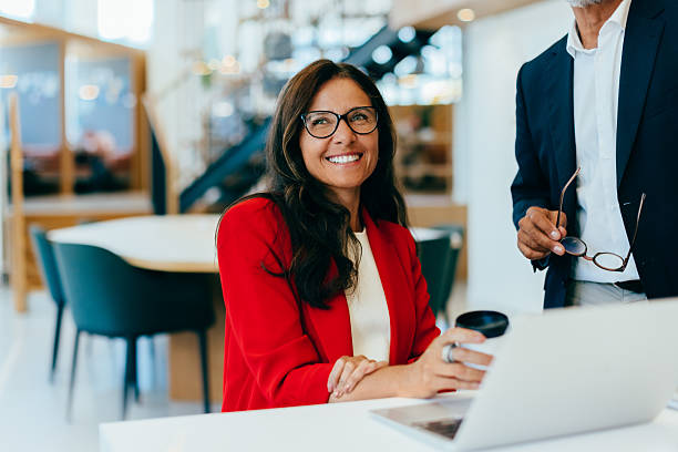 Confident businesswoman smiling in an office setting with professional demeanor