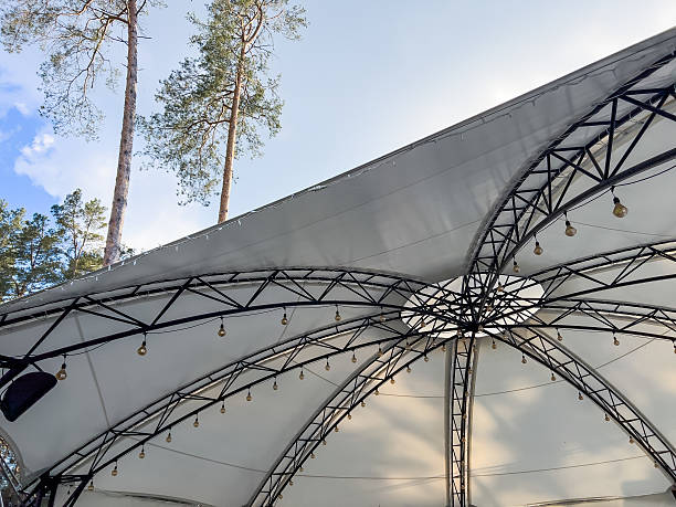 istock Iron framework of an outdoor canopy structure designed for hosting festive events. Sturdy and open design suitable for weddings, parties, markets, or public celebrations, providing support for lights, drapes, or other decorations. 2228006942