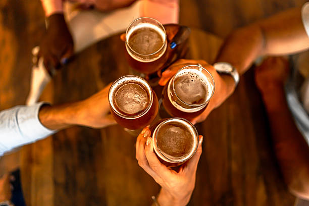 istock Friends toasting with beer glasses in a cafe 2228009669