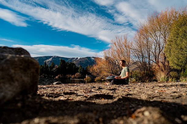 istock Mature man playing handpan in Patagonia, Argentina 2228010689