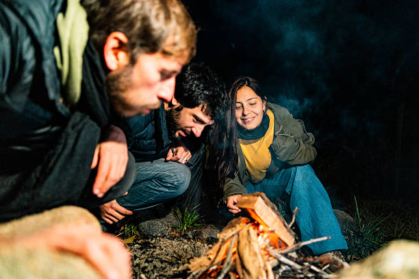 istock Friends setting up a bonfire for a night outdoors 2228010815