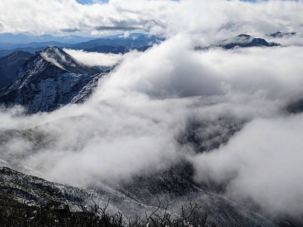 istock clouds covering the beautiful ridgeline that should be visible from Oki no Mimi on the snow-capped summit of Mt. Tanigawa in Minakami Town, Gunma Prefecture, Japan in October. 2228011223