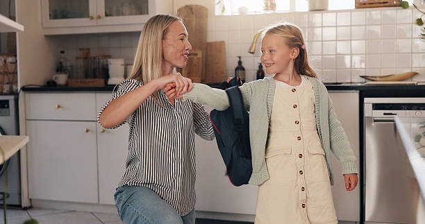 istock Kitchen, mother and child with backpack for school, help and bonding together with morning routine. Home, parenthood and mom with girl ready for leaving, education and learning on first day in house 2228023681