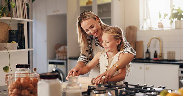istock Baking, woman and child with rolling pin in kitchen, learn and helping mom with dough or culinary skills. Cooking, mother and daughter with flour for meal prep, growth and development of kid in house 2228023686