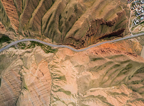 istock Top-down view of a road crossing a rugged terrain 2228027672