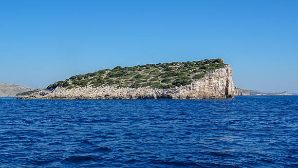 istock Rocky island with steep cliffs and sparse vegetation in the Kornati archipelago 2228029537