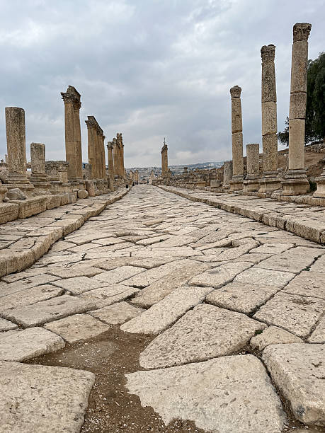 istock Ancient Roman stone-paved street lined with tall columns 2228029712