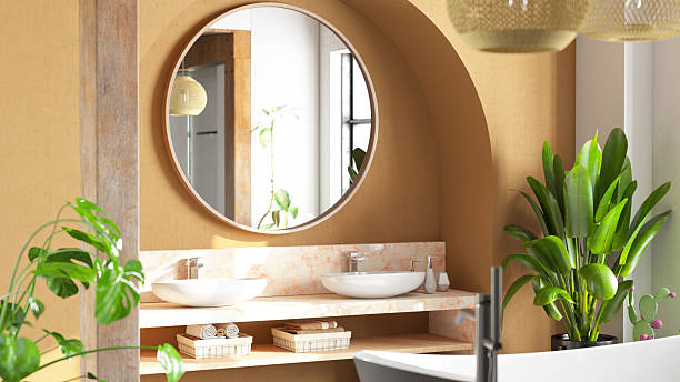 Stylish and minimalistic bathroom interior featuring a wall-mounted oval sink with a sleek black faucet, set against matte white large-format tiles. A floating cabinet adds functionality without compromising the clean aesthetic, while a large round mirror enhances the sense of space.Perfect visual for interior design inspiration, bathroom remodeling ideas, tile and fixture brand promotion, or showcasing modern bathroom accessories and trends.