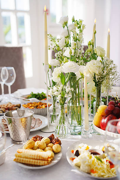 Elegant dining setup with floral decor for a gathering in bright sunlight
