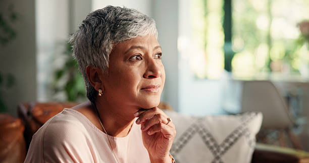istock Remember, thinking and senior woman in home for ideas, reflection and nostalgia on sofa. Decision, choice or elderly female person daydreaming with past memory, hope and peace in retirement house 2228035161
