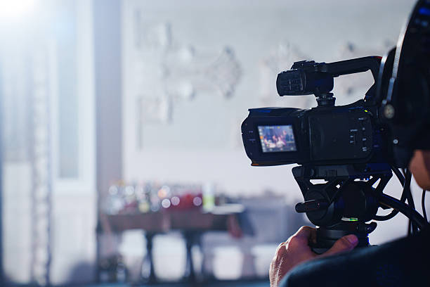 istock A professional videographer is filming a banquet hall event. 2228036264