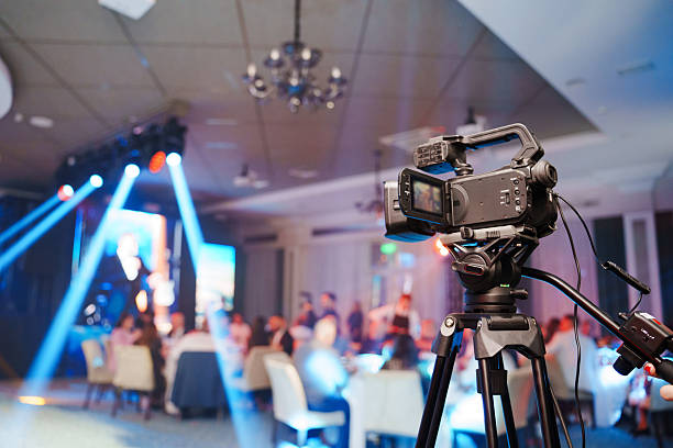 istock A professional videographer is filming a banquet hall event. 2228036569