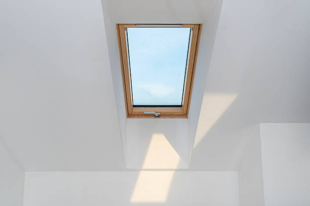 istock Attic with roof windows finished to a shell state, walls covered with plaster. 2228036829