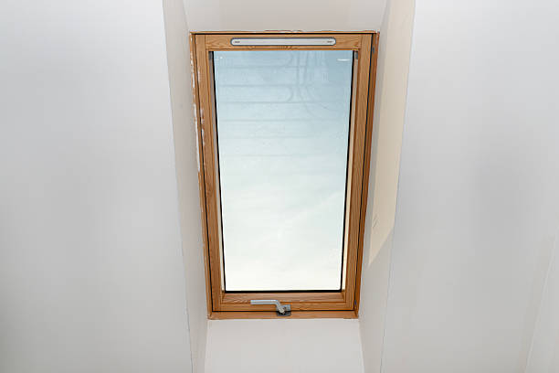 istock Attic with roof windows finished to a shell state, walls covered with plaster. 2228036935