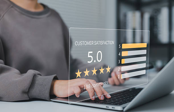 istock Customer Satisfaction Rating Concept. Person typing on laptop with showing five star customer satisfaction rating, bar graph, and review comment count, symbolizing service quality feedback. 2228037366