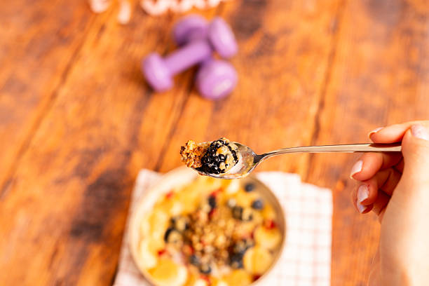 Hand Holding Healthy Breakfast Bowl
