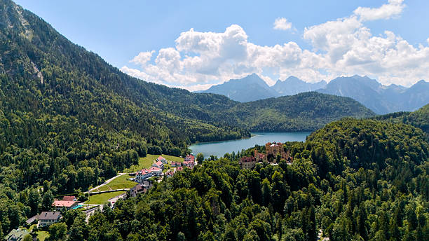 istock Mountain lake and alpine village surrounded by green forest 2228045026