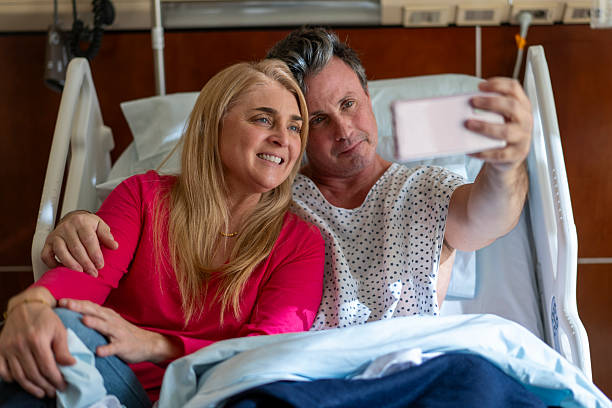 istock Smiling couple taking selfie in hospital bed 2228046801