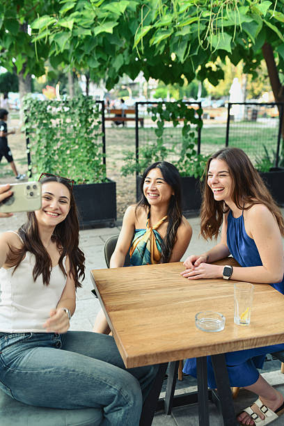 istock Beautiful Multiracial Friends Snapping Selfie While Enjoying In Outdoors Coffee Shop 2228047596