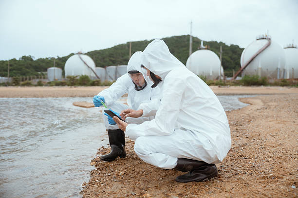 istock Scientists biologists and researchers in protective suits taking water samples from waste water from industrial. Experts analyze the water in a contaminated environment. 2228048106