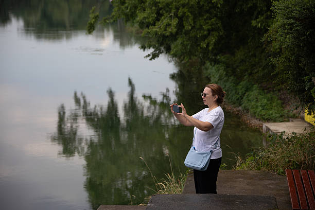 istock Attractive woman taking selfie on a lake 2228050697
