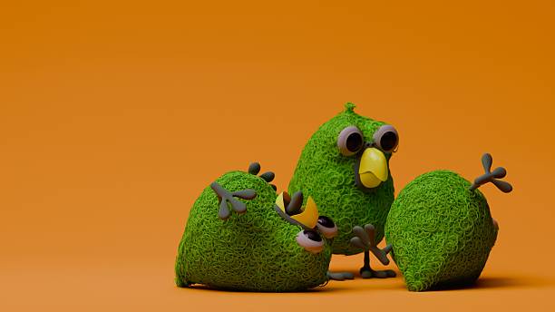 Three 3D grass textured green parrot figurines appear on a solid orange backdrop: one stands upright in front view while the other two lie on their sides with legs and wings splayed playfully.
